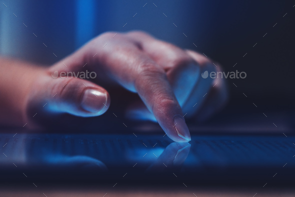 Extreme close up of female finger using digital tablet computer - Stock Photo - Images