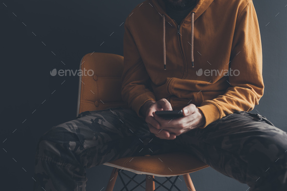 Casual man using smart phone - Stock Photo - Images