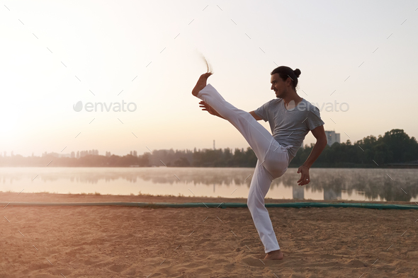 Capoeira on the beach, near lake in the park one performer, at s - Stock Photo - Images