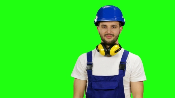 Foreman Picks up the Paper Planchette and Smiles on Green Screen alt