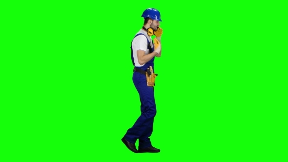 Builder Speaks on the Phone and Screams at His Subordinates on Green Screen alt