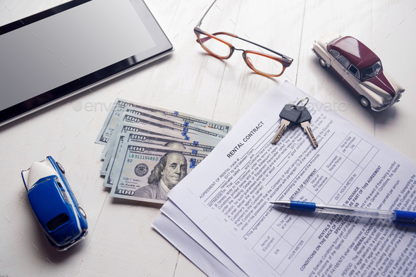 Rent contract with keys and us money on office table - Stock Photo - Images