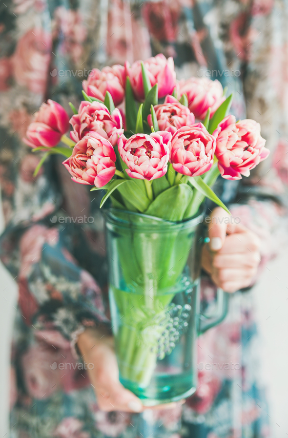 Woman in colorful dress holding bouquet of pink tulips - Stock Photo - Images