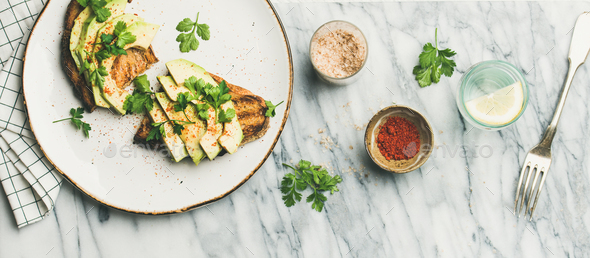 Avocado toast with seasoning and lemon water - Stock Photo - Images