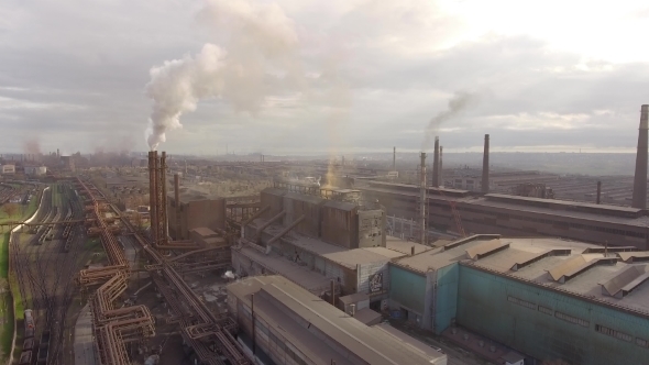 Aerial View of Industrial Steel Plant. Aerial Sleel Factory. Flying Over Smoke Steel Plant Pipes alt