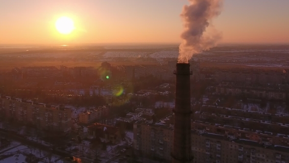Aerial Shot of High Brick Tube with Smoke Stream in Ukrainian City at Sunset