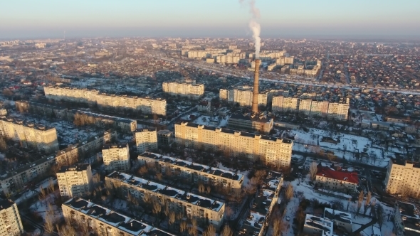 Aerial Shot of High Cooling Chimney with Smoke Stream in City in Winter