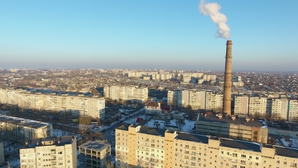 Aerial Shot of Brick Cooling Tower with White Smoke in Snowy City in Winter
