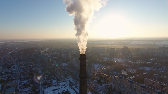 Aerial Shot of Giant Cooling Chimney with White Smoke in Snowy City in Winter