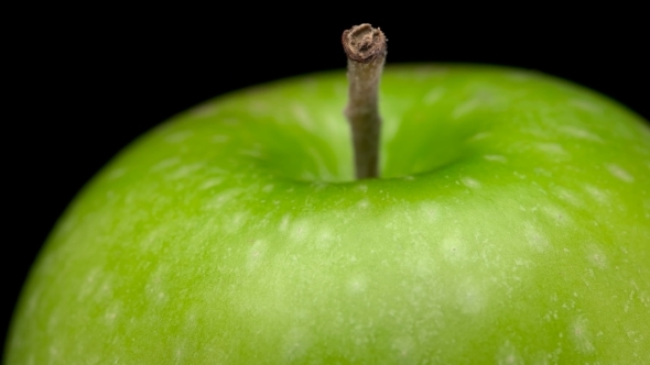 Beautiful, Green Apple Spinning on Black Background alt