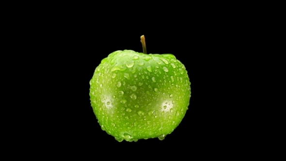 Beautiful Green Apple with Water Drops Rotates on Black Background alt