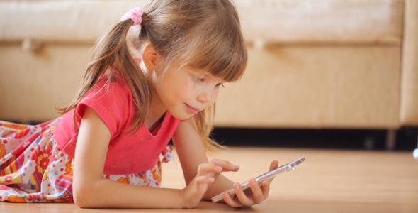 Little Girl Watching Photos in Smartphone