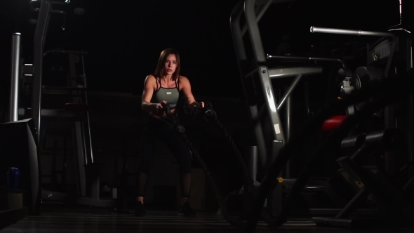 Female Athlete Working Out with Heavy Ropes at the Gym alt