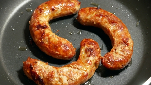 Overhead  Frying Link Sausage Fast Food in Cast Iron Skillet alt