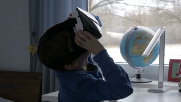 Boy in Virtual Reality Glasses Watching 360 Degree Video -