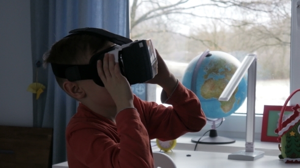 Boy in Virtual Reality Glasses Watching 360 Degree Video