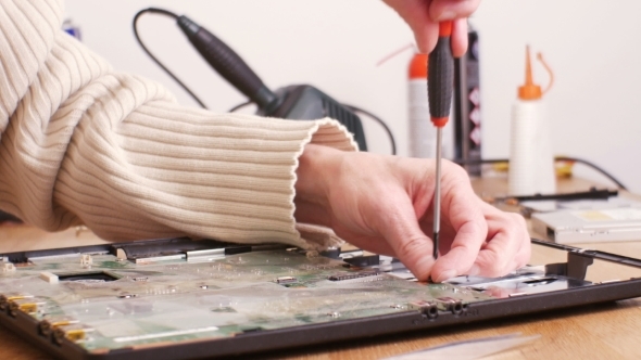 Assebling a Laptop with a Screwdriver After Repair -