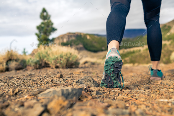 Sole of shoe walking in mountains on rocky footpath - Stock Photo - Images
