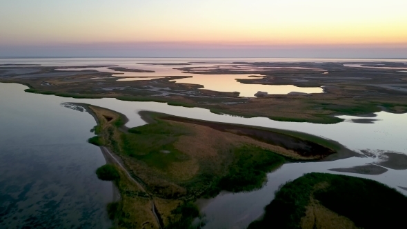 Shallow Water Near the Sea at Sunset. Footage. Aerial View. Sand Island Top View