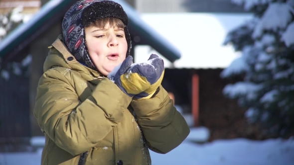 Child Blows on the Snow and It Flies Away