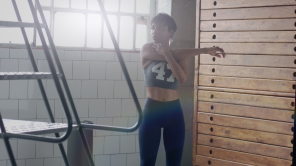 Young Fit and Tone Up Woman Doing Heating Before a Fitness Workout in Sunny Loft alt