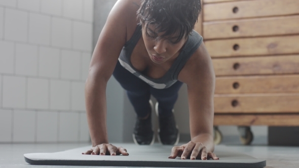 Young Fit and Tone Up Woman Doing Fitness Workout with Plank Elements for Strenght Abs in Sunny Loft alt