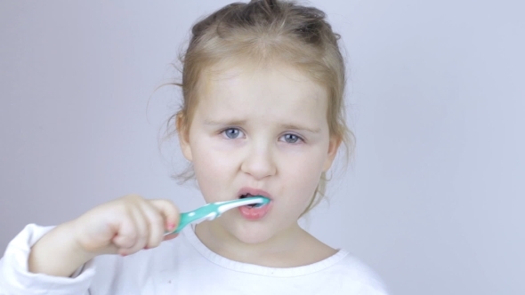 Young Girl Brushing Her Teeth at Home
