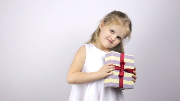 Happy Girl Holding Gift and Showing Thumbs Up