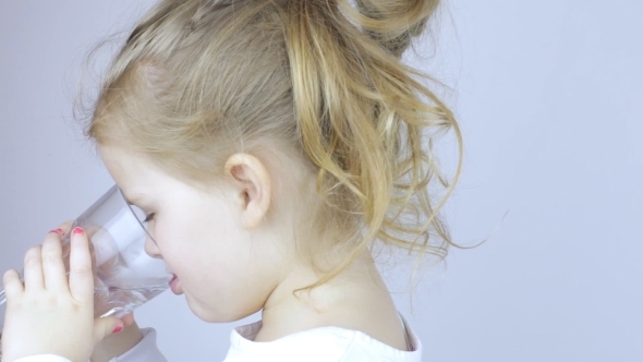 Young Girl Drinks Water From Glass