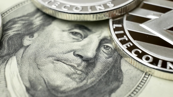Litecoin LTC Coins Rotating on Bills of 100 Dollars alt