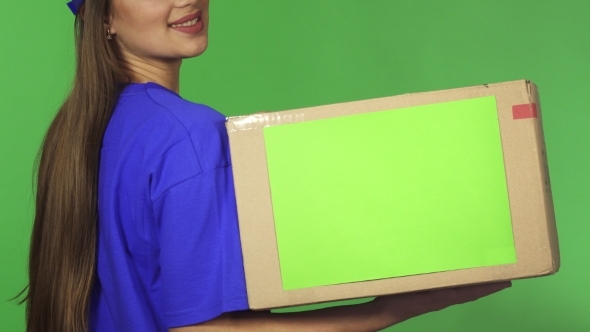 Cropped Rearview Shot of a Smiling Delivery Woman Holding Cardboard Box alt