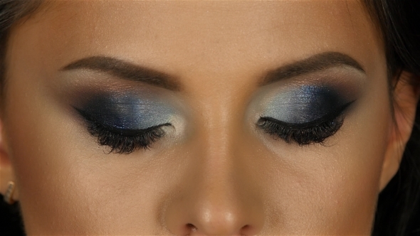 Beautiful Girl with Makeup Taking Looks Straight and Blinks alt