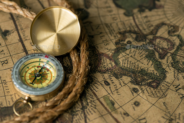Old compass on vintage map with rope - Stock Photo - Images
