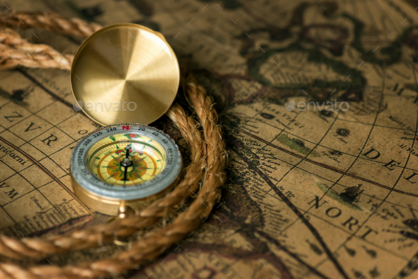 Old compass on vintage map with rope - Stock Photo - Images