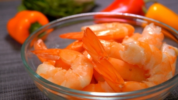 Hand Puts Juicy Tasty Shrimps in a Bowl alt