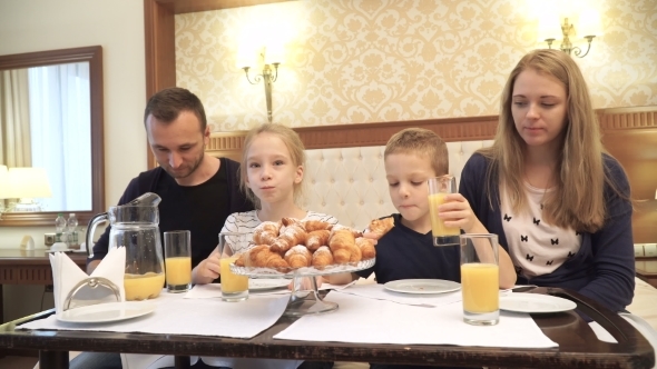 a Happy Family Having Breakfast in Hotel Room