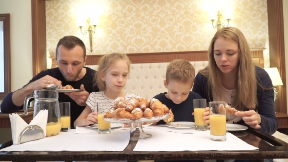 a Happy Family Having Breakfast in Hotel Room