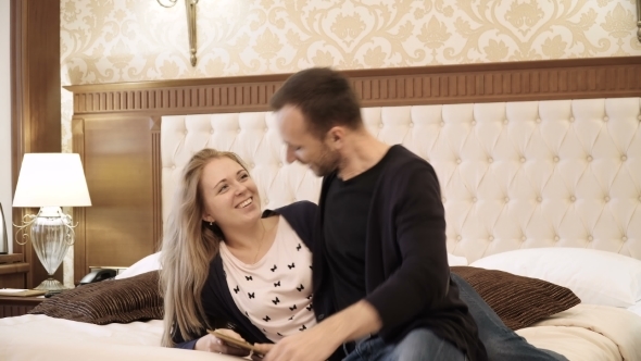 Young Couple Calls To the Reception Desk To Order Room Service