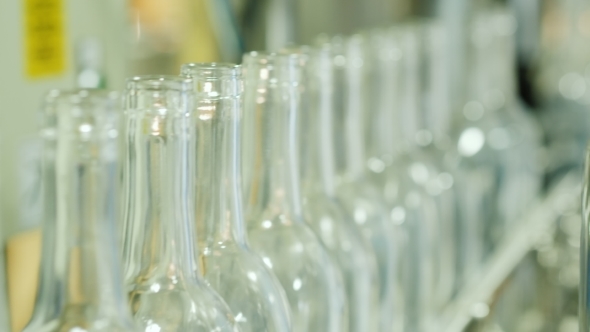 Empty Bottles for Alcoholic Drinks on the Conveyor. Wine Industry alt