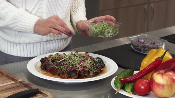 Woman Garnishing Delicious Dish with Greens Cooking at Home alt