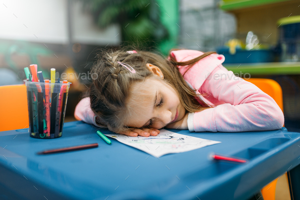 Little girl sleep in play area, pet shop - Stock Photo - Images