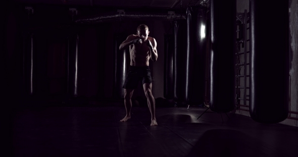 Kickboxer Shadow Boxing As Exercise for the Fight Fighter Training Punching Boxing in the Darknes alt