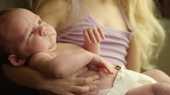 New Baby Brother Being Held By Sister