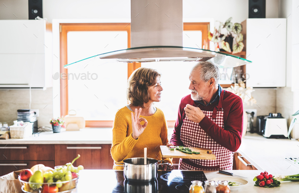 Senior couple preparing food in the kitchen. - Stock Photo - Images