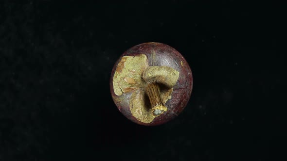 Rotating Tropical Exotic Fruit Mangosteen On A Black Background.