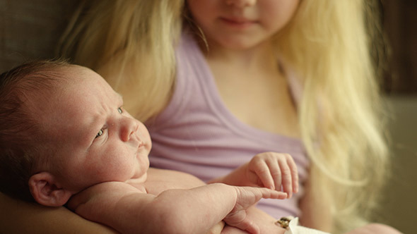 New Big Sister Holds Baby Brother