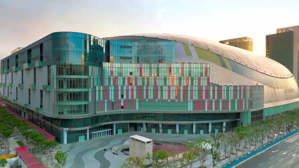Aerial approaching shot of modern Taipei Dome DaJudan during sunny day in the morning. alt