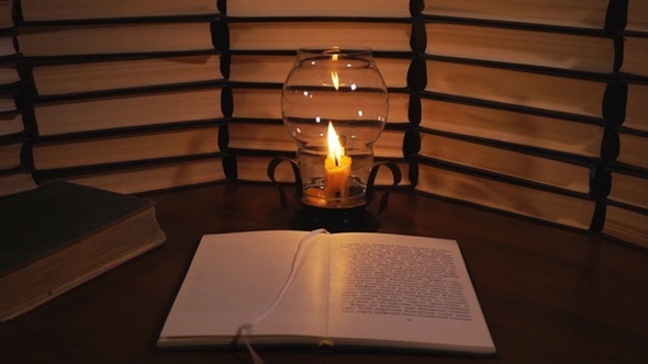 Open Book And a Burning Candle