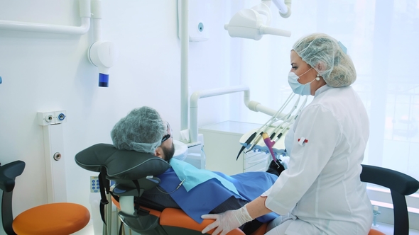Health and Dental Care, Woman at Work As Dentist and Doctor, Talking To a Male Patient Discuss