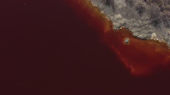 Red acidic water from mining site 4K aerial footage alt